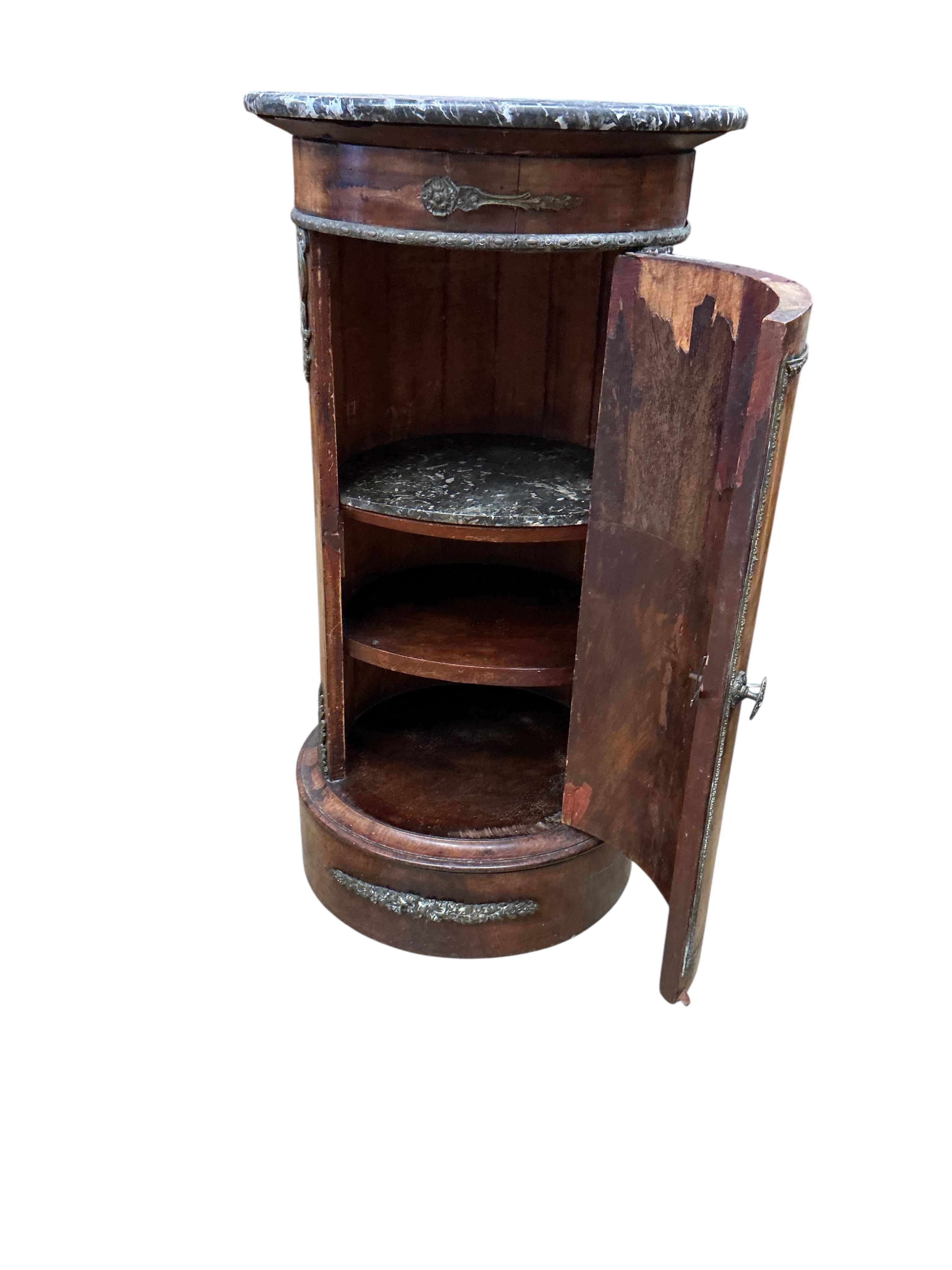 A 19th century French ormolu mounted mahogany cylindrical pot cupboard, with dished grey marble top, diameter 40cm, height 75cm